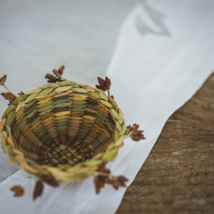 Intricately hand-woven miniature basket usiing dried rushes and seed head detailing