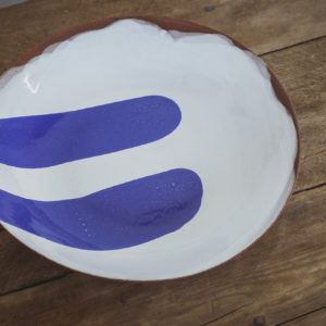 Terracotta serving bowl with a grey base coat and two brush strokes of cobalt blue glaze