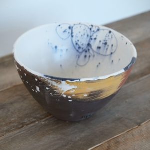 inside of bowl showing inky, gestural marks on a white glazed base