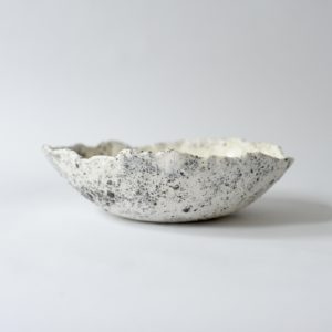 white and grey, heavily textured dining bowl, set against a white backdrop.