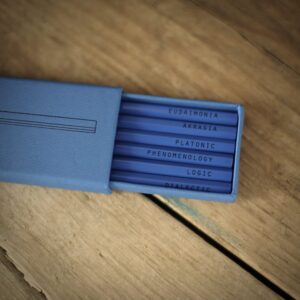 A blue slide-out box, containing six pencils the philosophical keywords: Eudaimonia Akrasia Platonic Phenomenology Logic Dialectic