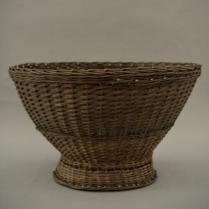 A large, handwoven born willow basket shown against a light grey background