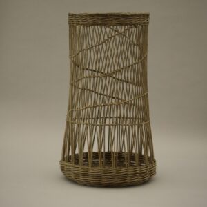 A tall and narrow woven willow basket with an open weave