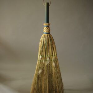 A handcrafted handbroom with pieces of flora and fauna from Cadair Idris incorporated into the broom.