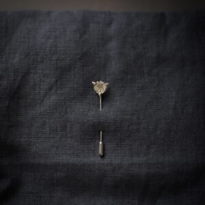 Silver acorn crest pin made from a vintage coin.