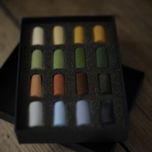 a set of 16 small soft pastels in a variety of earthy colours.